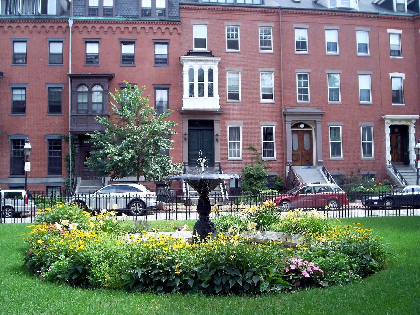 Brick homes and a flower garden at Union Park in Boston’s South End